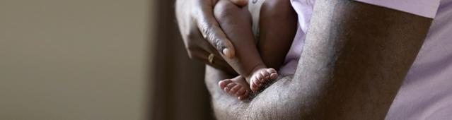 Baby feet in parent’s arms