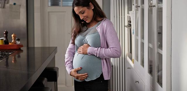 Pregnant mother preparing for baby and holding her stomach