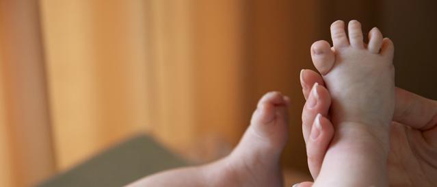 Newborn baby getting a foot massage