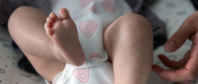 Newborn baby massage on legs